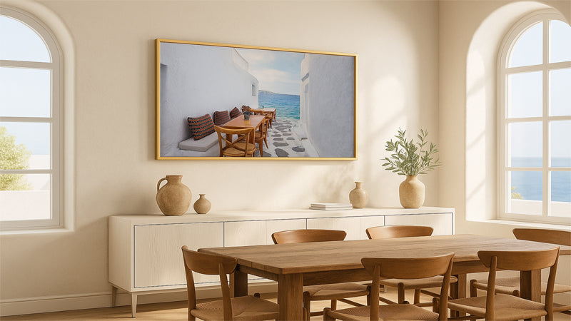Dining room with wooden table and chairs, white cabinets, and a large framed picture on the wall.